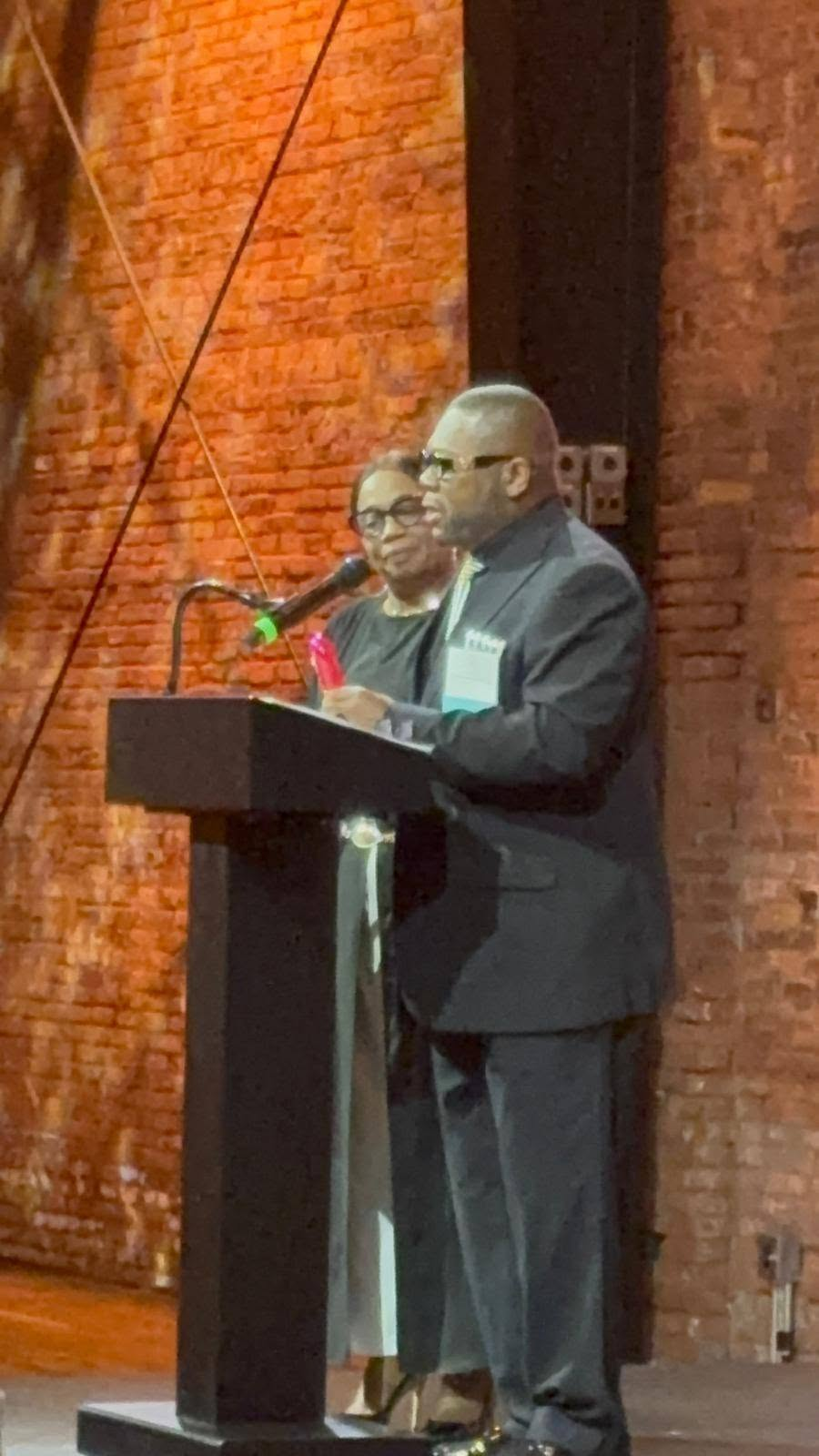 Clifford Scott speaking at a podium