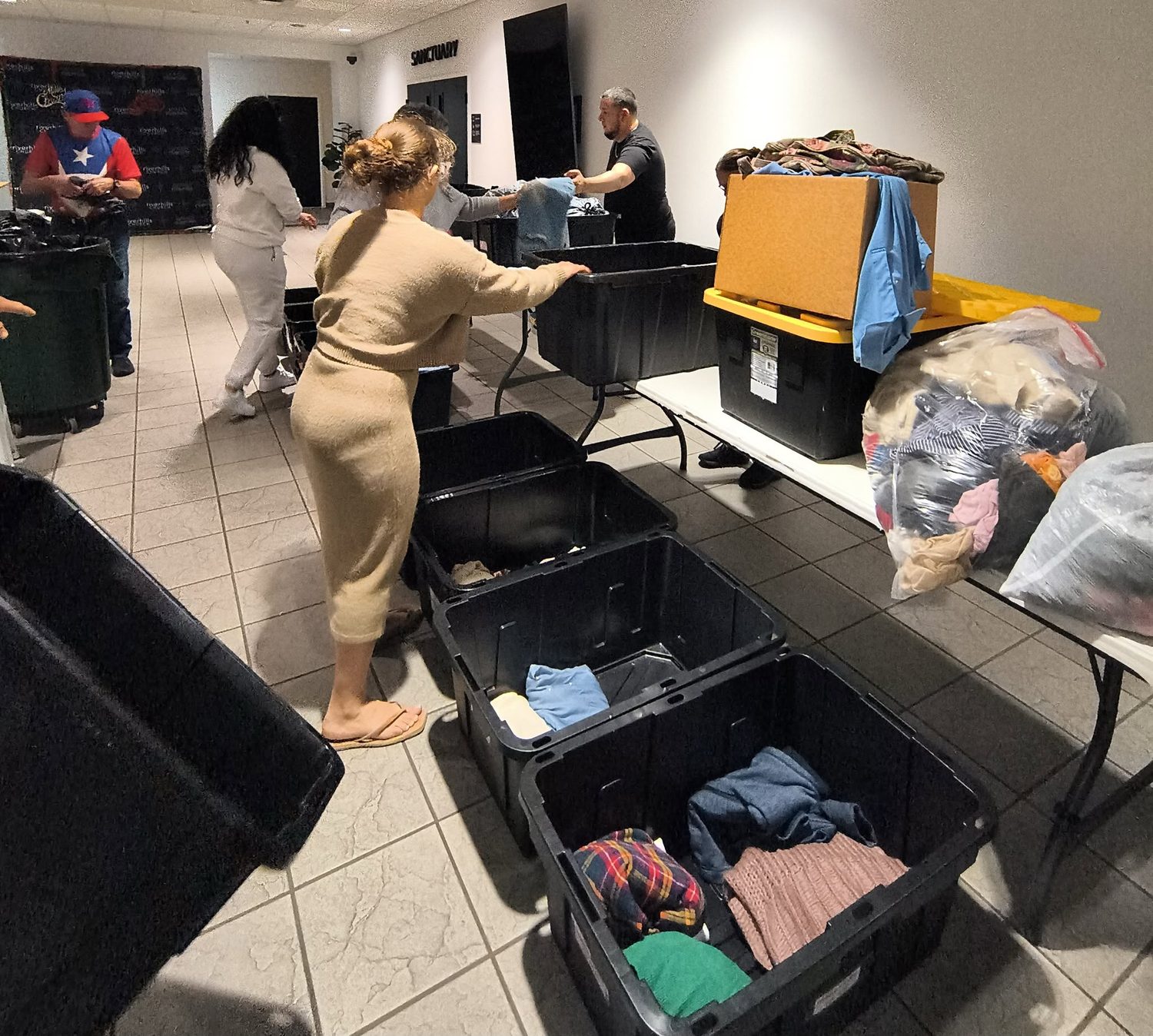 Volunteers sorting clothing donations