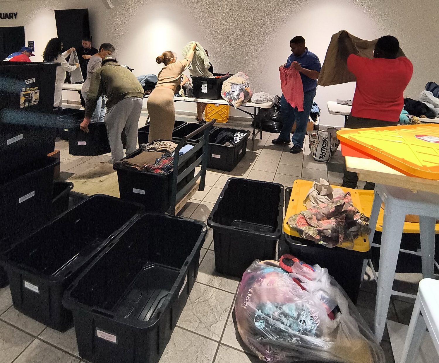 Volunteers sorting clothing donations for outreach