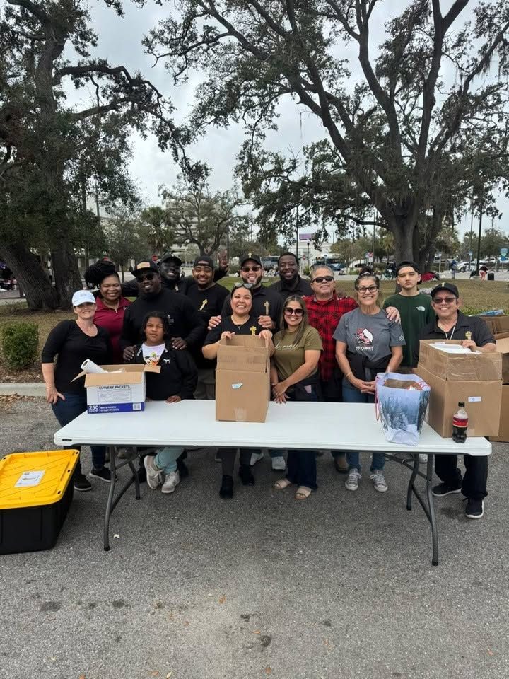FFF volunteers gathered at an outdoor outreach table